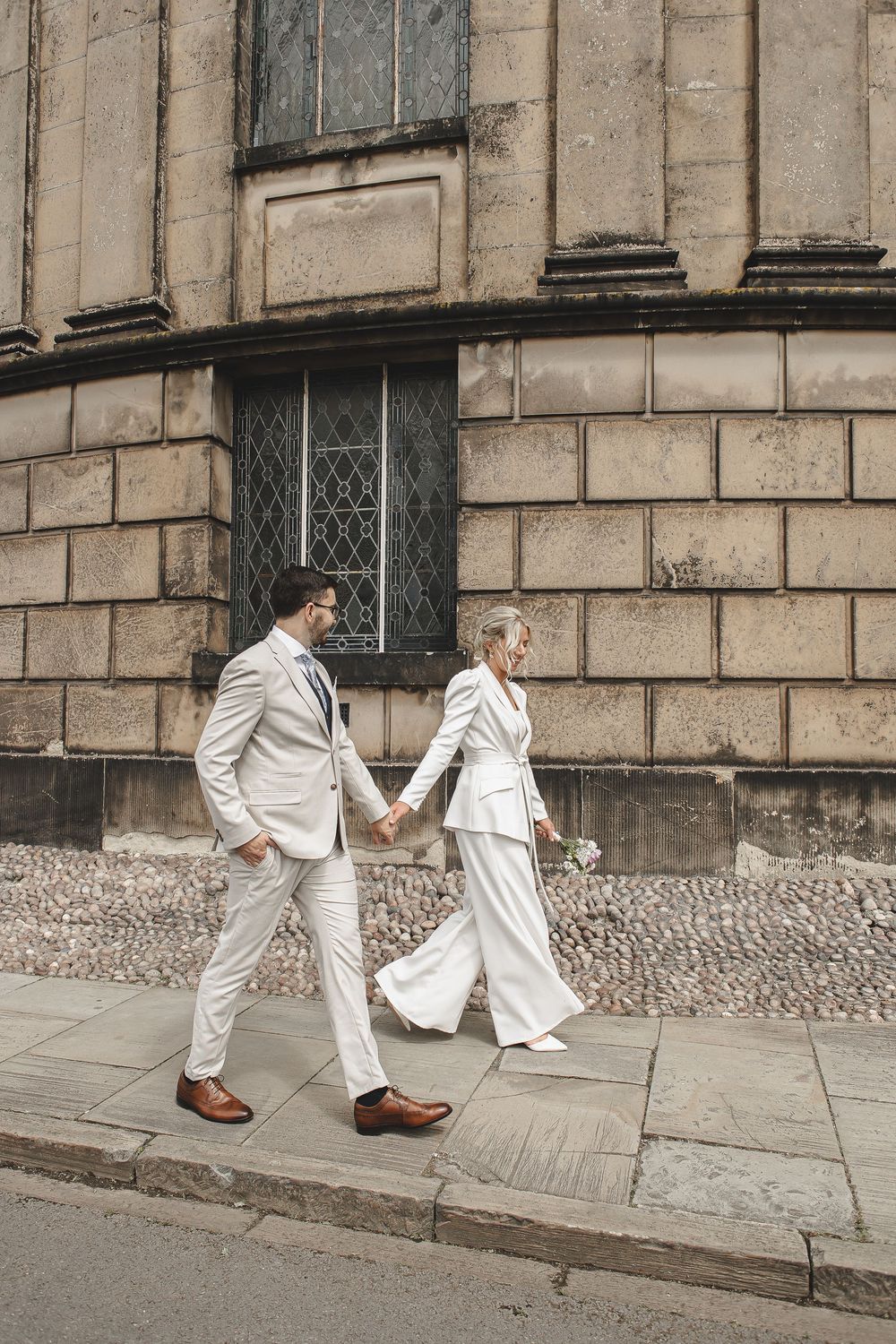 Sequence of photos showing white-clad figures walking along a stone building facade.