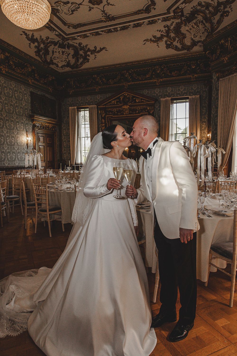 Romantic dance sequence in an elegant ballroom with ornate decor and vintage chandeliers.