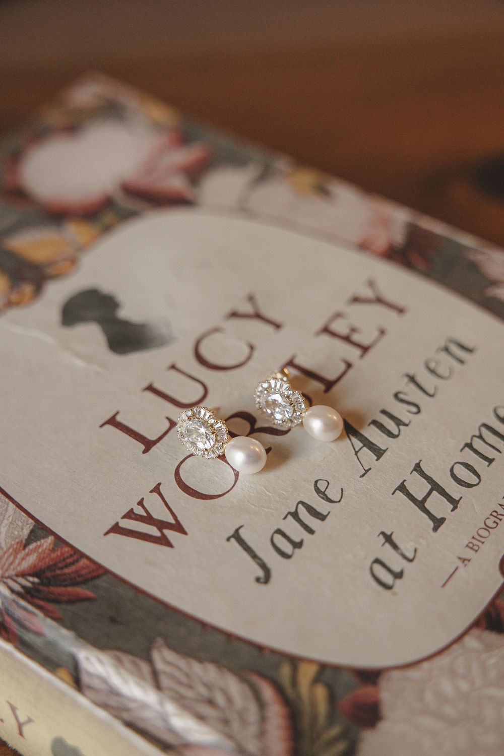 Close-up macro shots of book pages with elegant typography and pearl details showing text and decorative elements.
