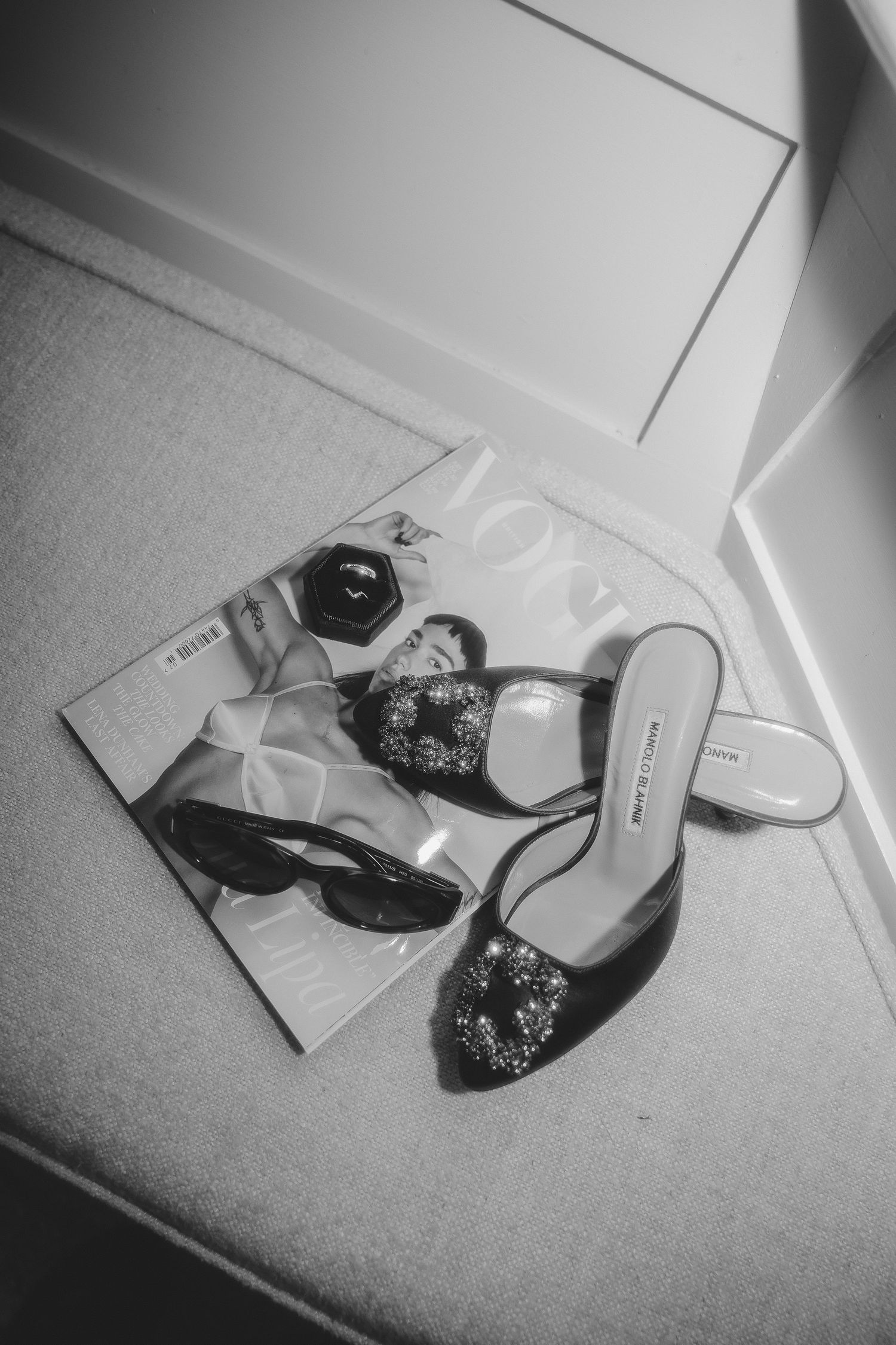 Black and white photo series showing elegant high heel shoes with sparkly embellishments on a light carpet.