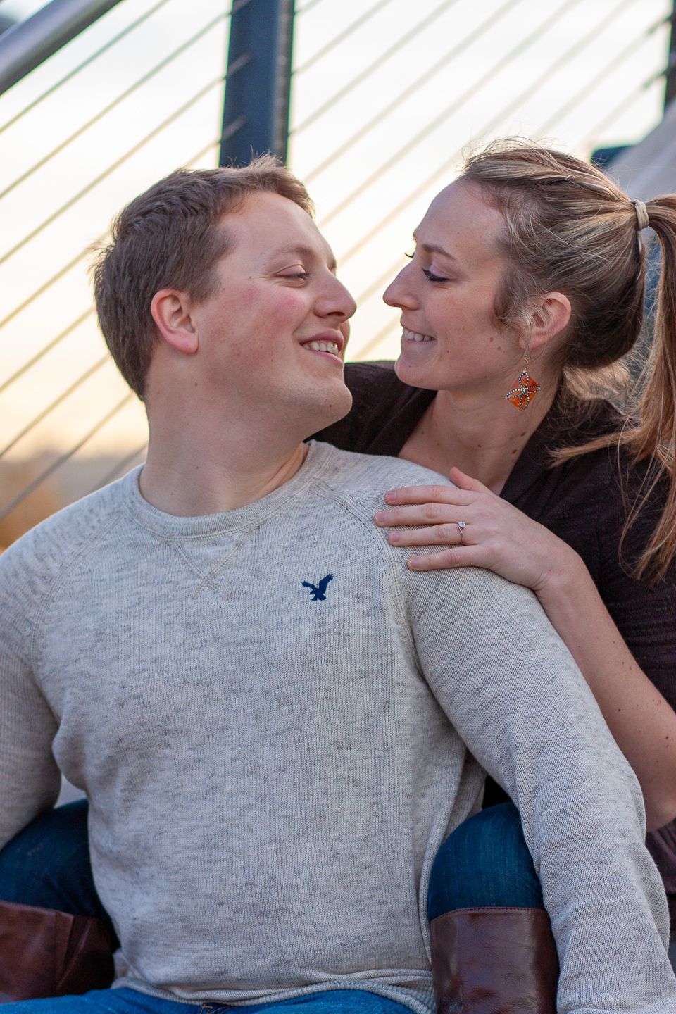 A candid moment of a couple laughing together during an engagement session.