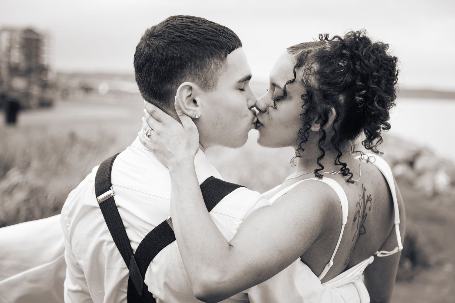 A romantic wedding photo sequence showing six black and white images of a couple sharing tender kisses outdoors.