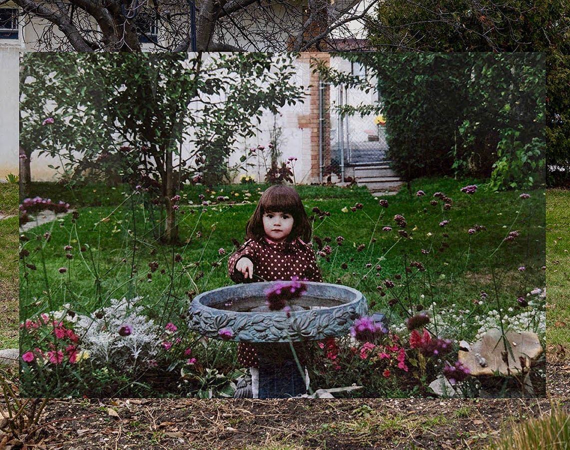Girl in backyard, past and present