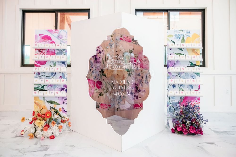 Abstract watercolor-style banners with pink and purple hues displayed in a white gallery-like space.