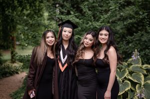 Group graduation photos taken outdoors with dark academic gowns against lush green foliage.