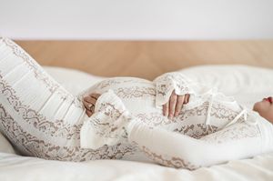 A white lace wedding dress detail shown in a series of connected photos highlighting delicate fabric patterns.
