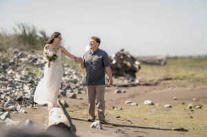 Couple in romantic poses at trash dump location during outdoor photo session.