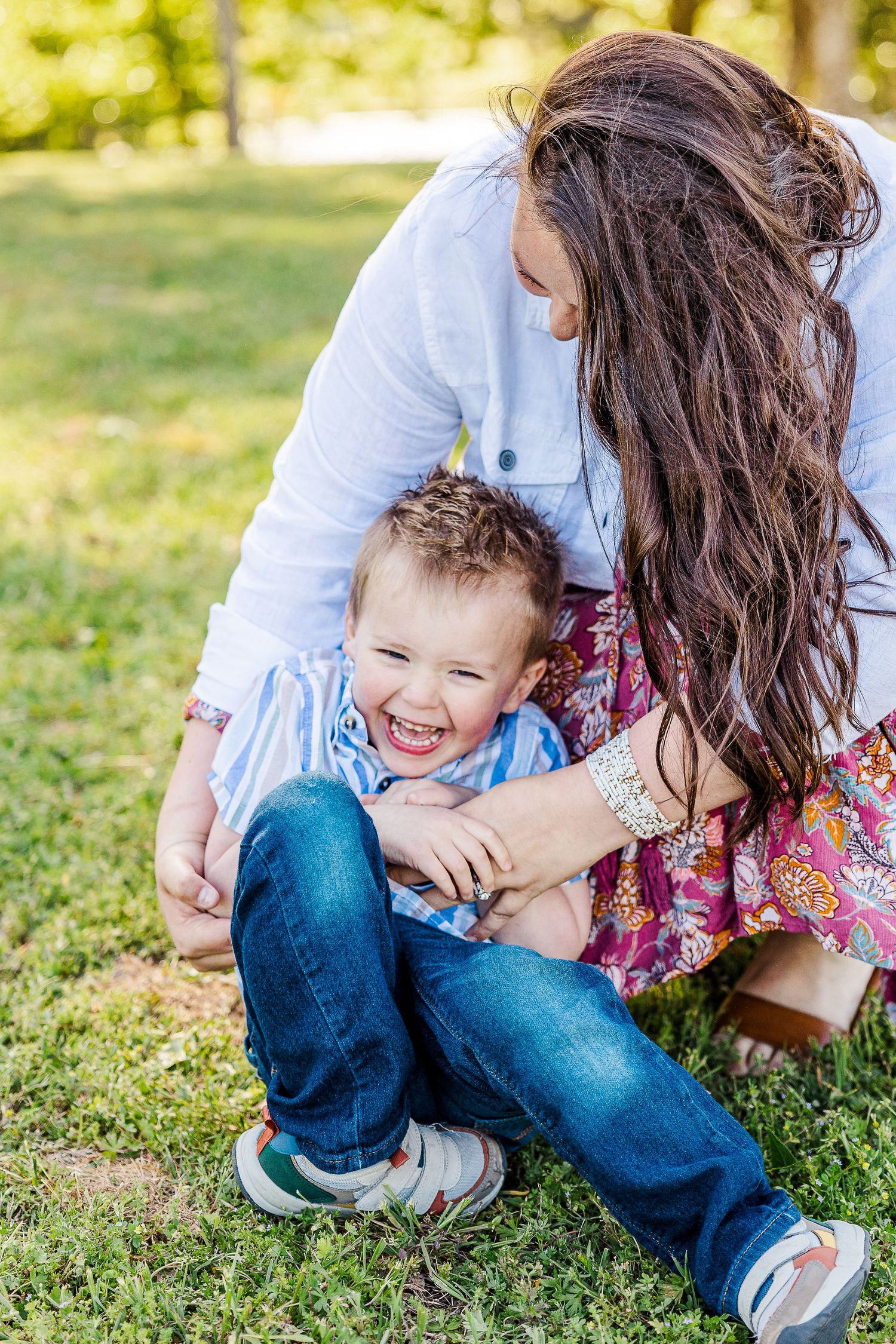 Playful moment captured on green grass in sunny outdoor setting.