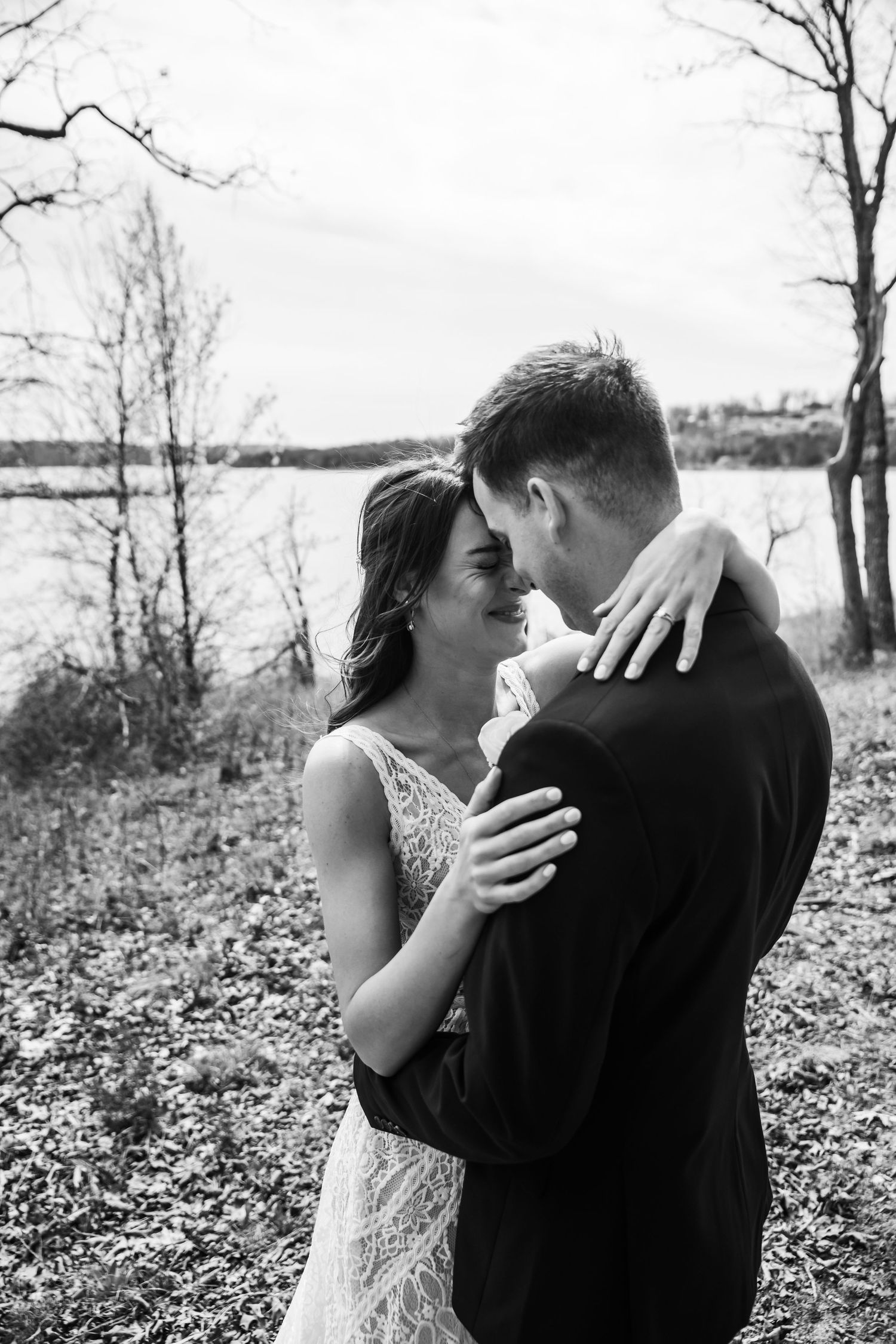Newlyweds share intimate moment on vintage couch with bride wearing cowboy boots.