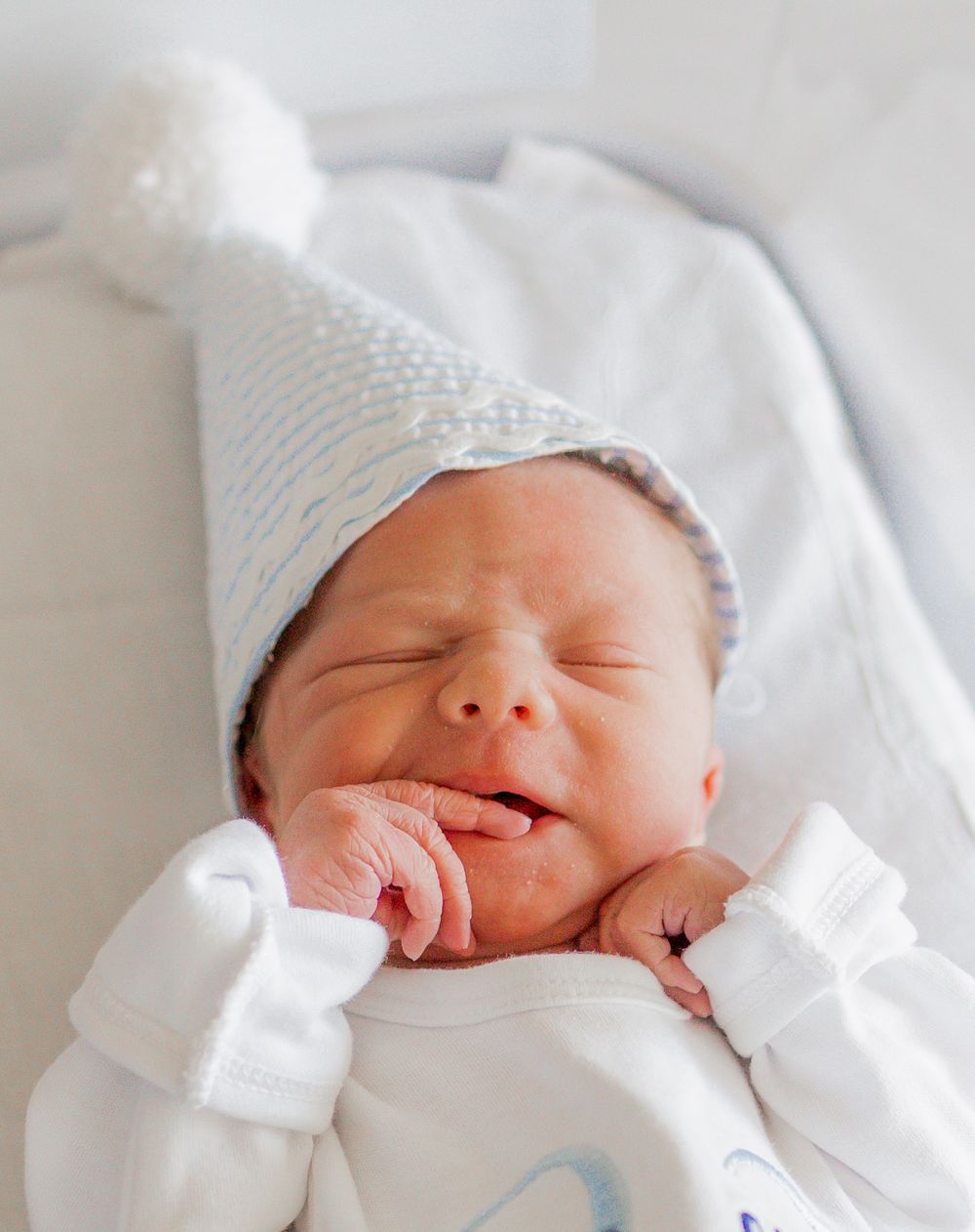 close up of newborn in birthday hat