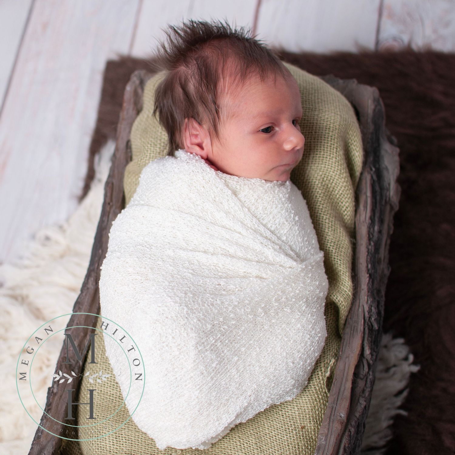 boho photo of newborn baby wrapped woodland theme
