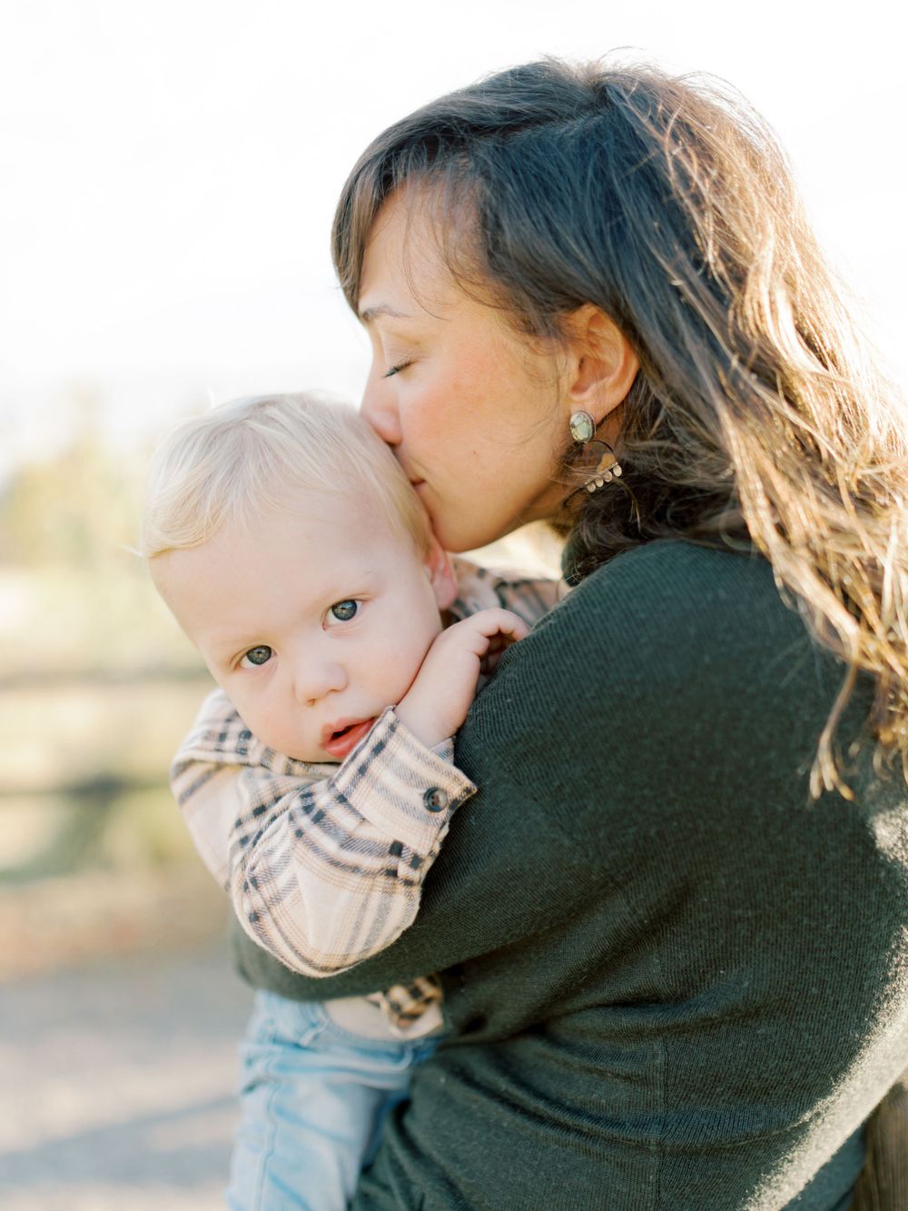 Mother and son cuddling. Taken by Kaitlin Stoltenberg, Family and Newborn Photographer in Chico, California.