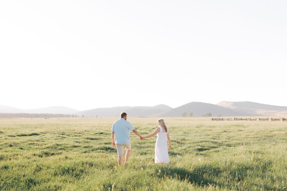 Couple photographed in wide open field in Northern California. Taken by Kaitlin Stoltenberg, Family and Newborn Photographer in Chico.