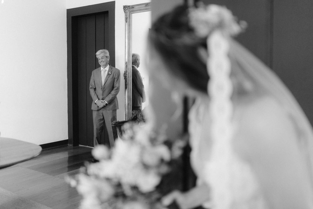 Black and white photo capturing a first look moment before the wedding ceremony.