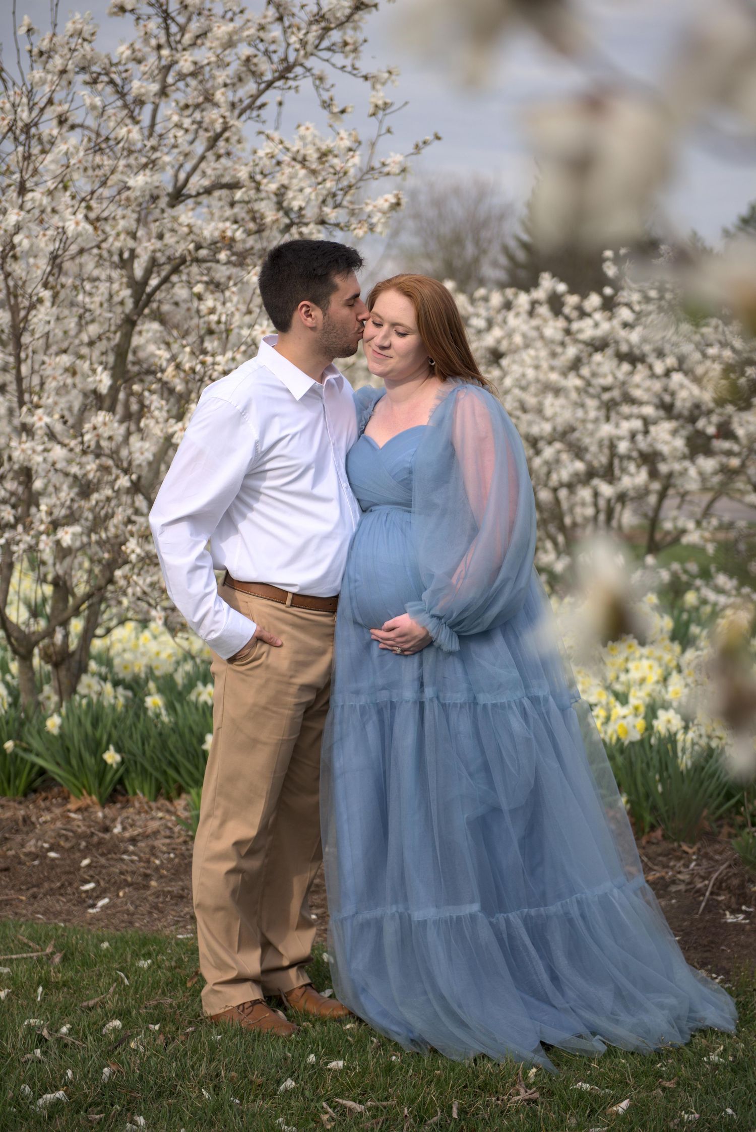 A man and woman embrace at Cox Arboretum.
