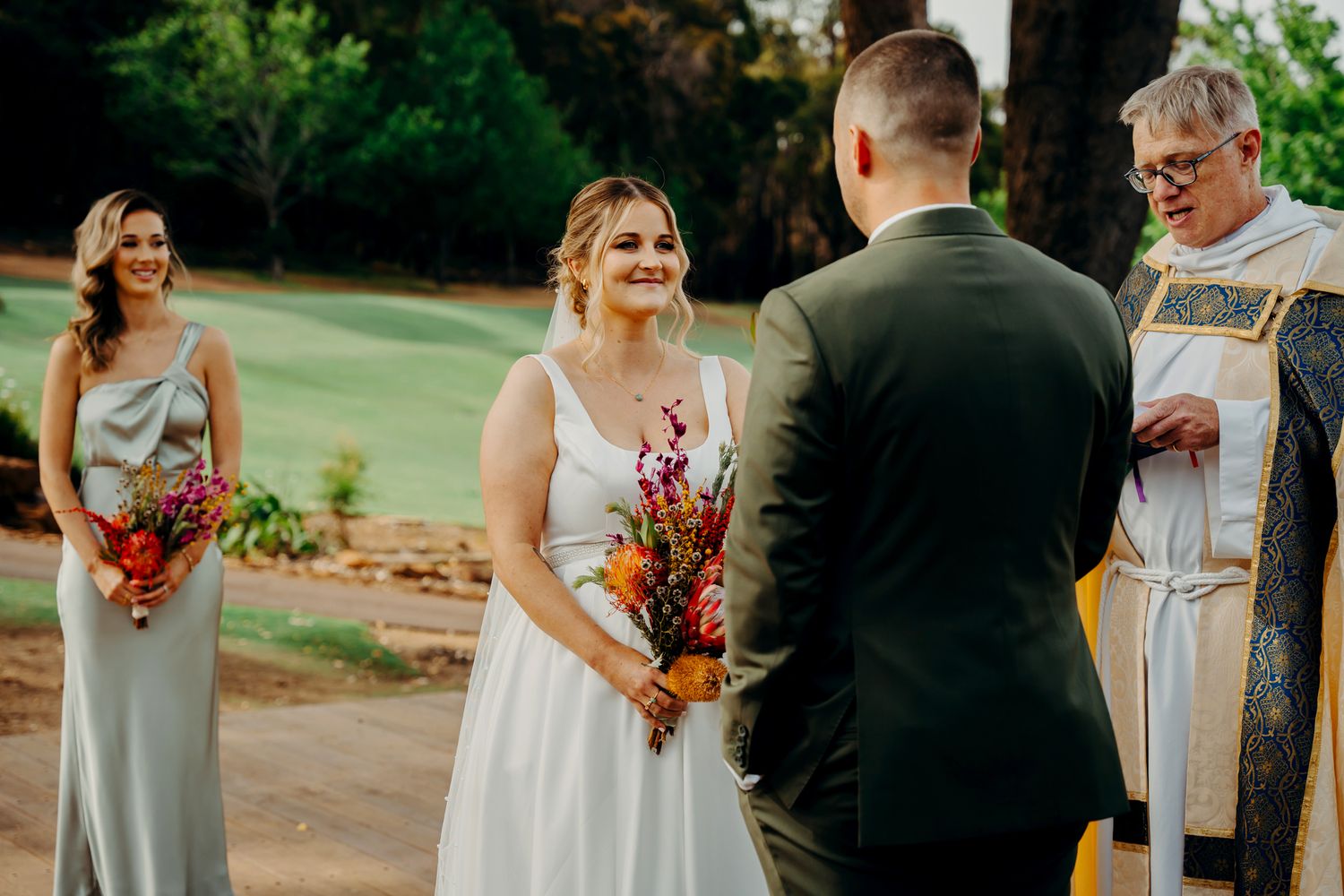 An outdoor wedding ceremony takes place on a beautiful autumn day.