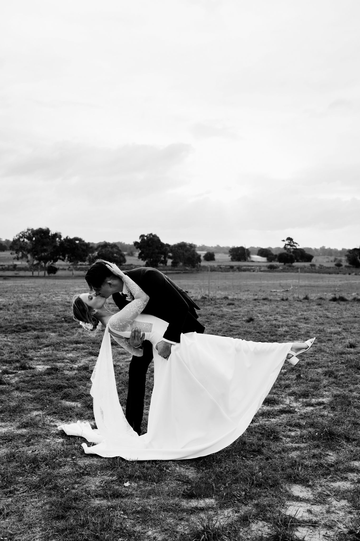 A romantic black and white sequence shows two figures dancing with flowing white fabric in an open field.