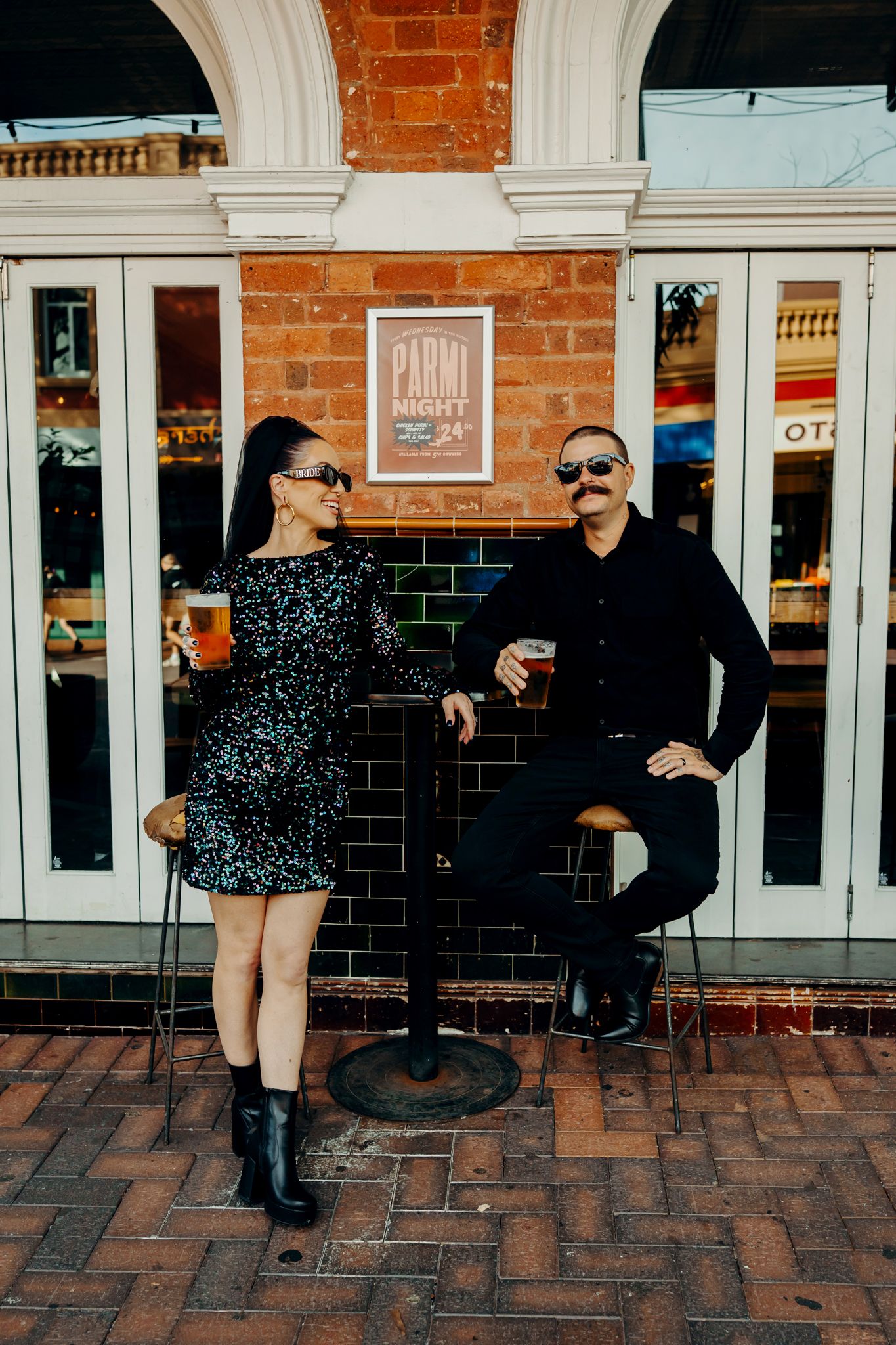 A triptych sequence of a couple dancing together on brick pavement outside a building with white columns and red brick walls.