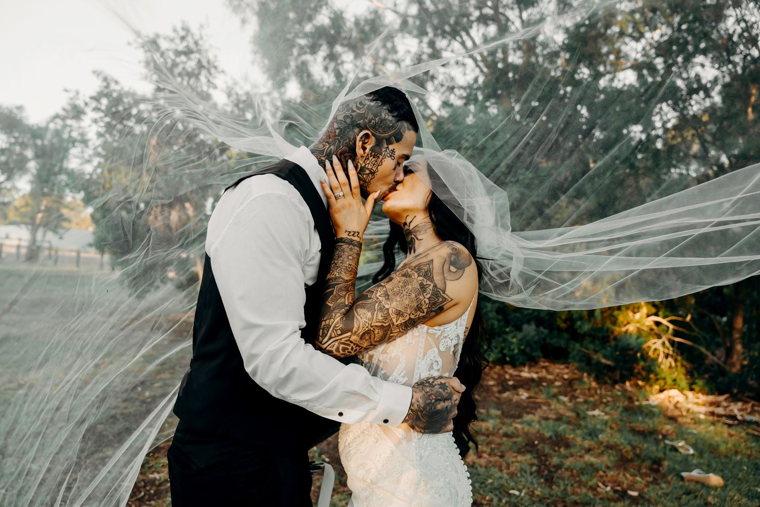 Artistic wedding portraits capture intimate moments between the newlyweds in a natural outdoor setting.