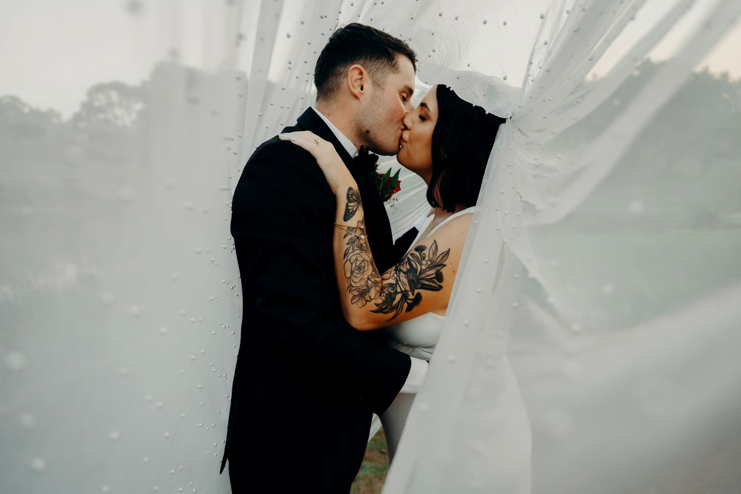 A romantic black and white wedding photo collage shows intimate moments between a bride and groom surrounded by foggy atmosphere.