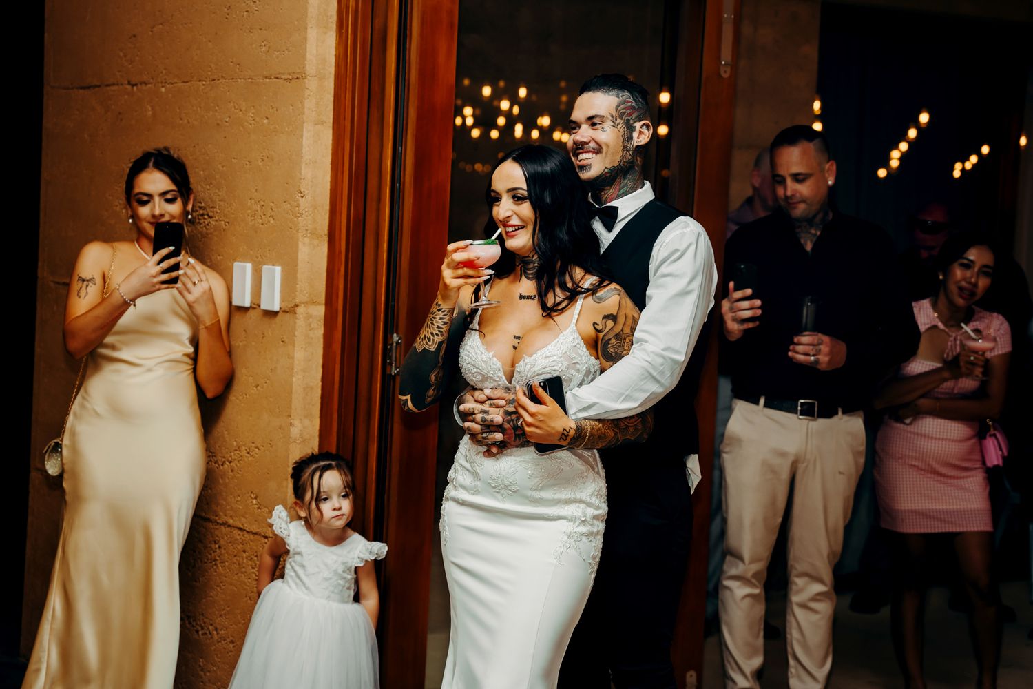 A collection of candid moments at a wedding venue showing tender interactions between guests at night.