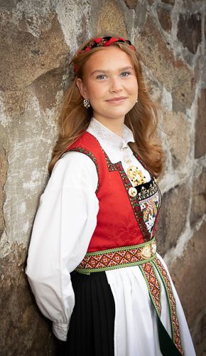 A series of photos showing a young person wearing traditional Norwegian folk dress with red and black embroidered details.