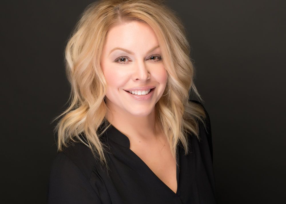 Commercial headshot of a corporate leader against a soft blurred background