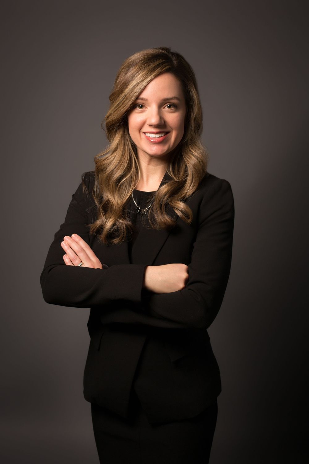 Professional female executive smiling during an on-location headshot session
