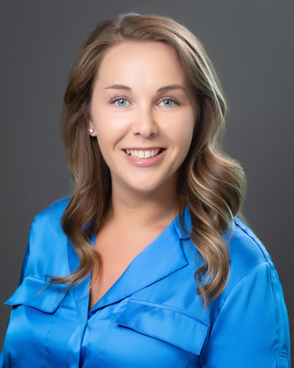 Commercial headshot of a corporate leader against a soft blurred background