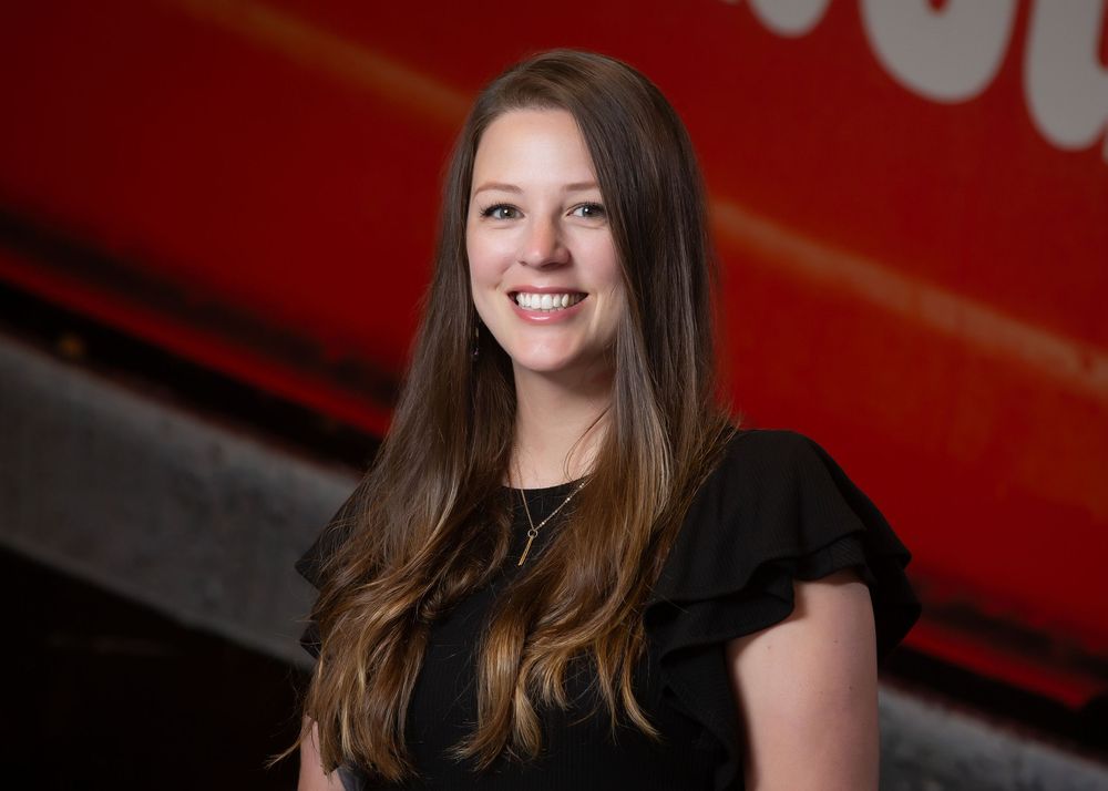 Environmental corporate headshot of a woman in a modern Fargo office setting