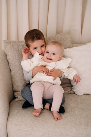 Familiefoto tijdens cake smash fotoshoot met broer en baby in daglichtstudio