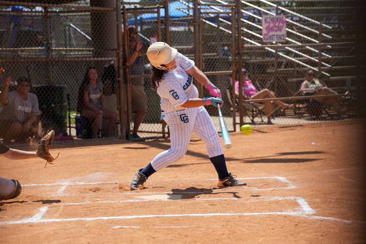 Baseball player in pinstripe uniform preparing to bat at home plate.