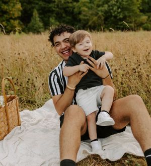 A joyful moment shared between parent and child in a sunny field.