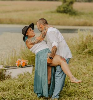 Romantic couple embracing outdoors in casual attire.