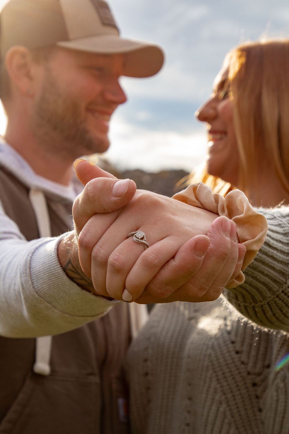 Close-up sequence of hands exchanging rings during an outdoor wedding ceremony at sunset.