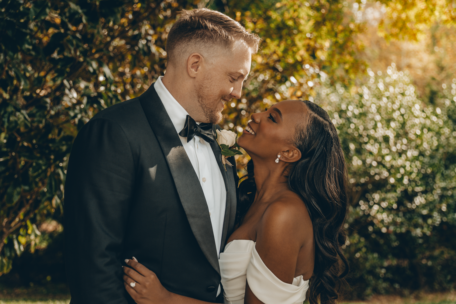 Romantic wedding couple embracing outside elegant white building.