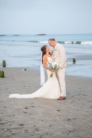 A romantic beach wedding photoshoot sequence with a couple in white attire on sandy shores.