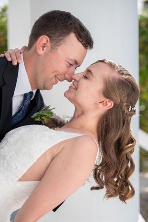 An intimate close-up wedding portrait showing a tender moment between newlyweds.