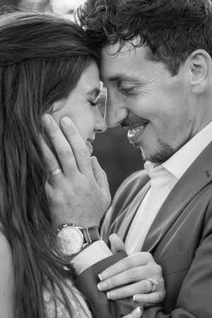 An intimate black and white wedding portrait showing tender emotional connection.