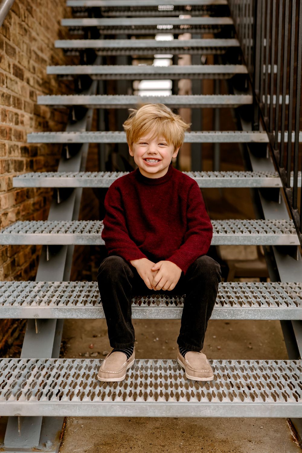 Five sequential photos showing someone sitting on metal bleachers in a burgundy sweater with brick wall background.