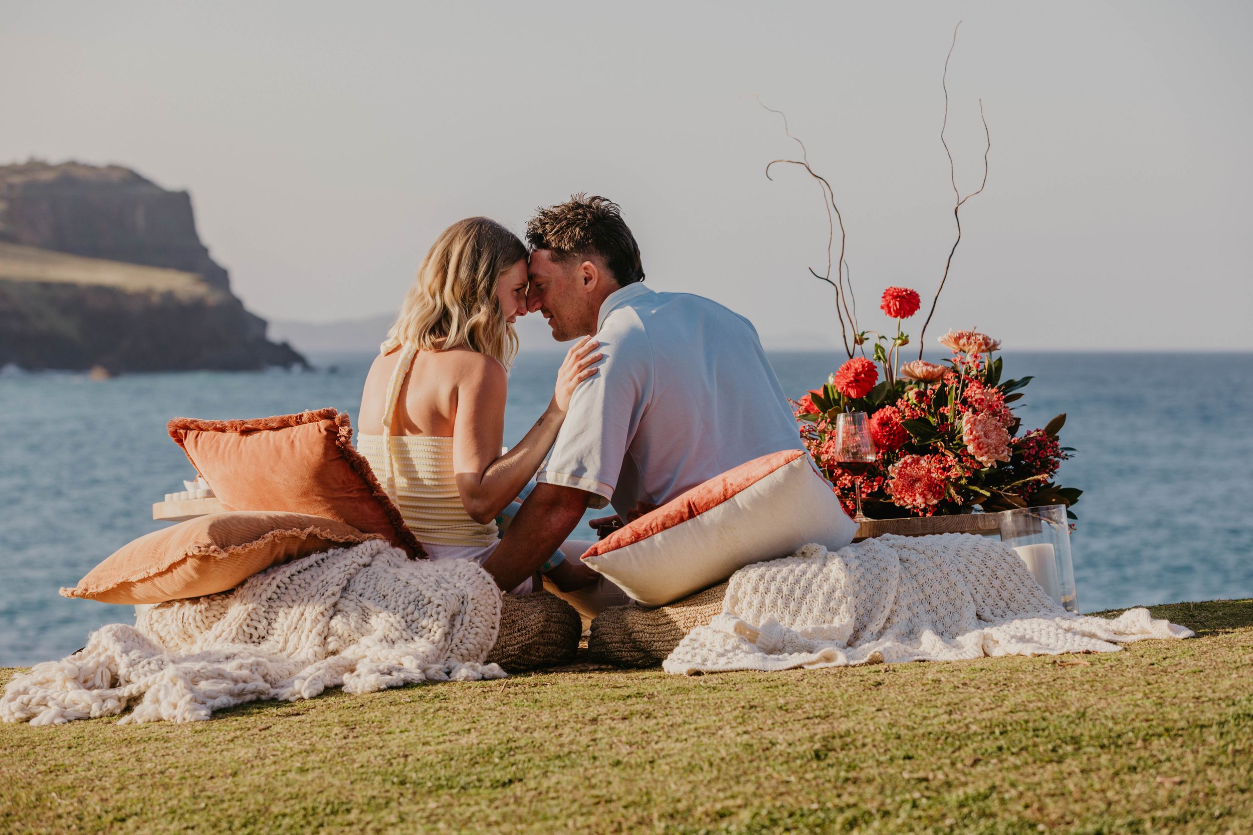 Romantic Byron Bay beach proposal with luxury picnic overlooking the ocean, captured by a Byron Bay proposal photographer at sunset.