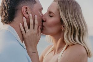 Couple kissing on beach in Gold Coast Australia during the day to celebrate their engagement