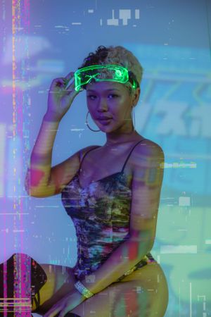 Artistic portrait with neon lighting effects showing someone wearing glowing green glasses in a cyberpunk-inspired setting.