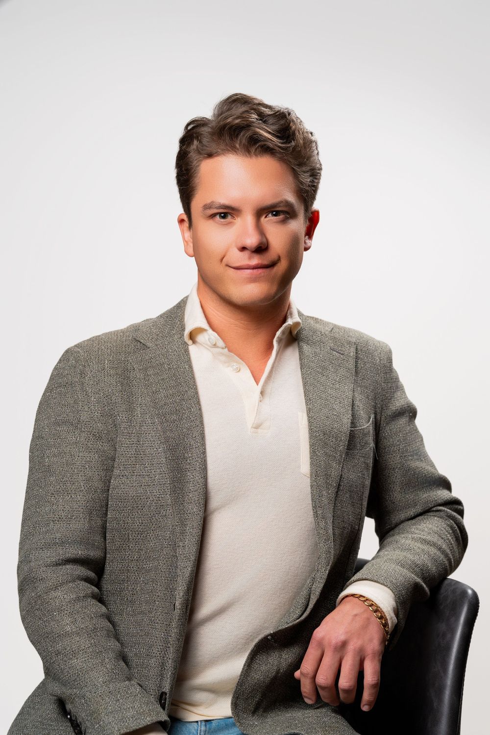 Professional headshots of someone in a grey blazer and cream shirt against white background.