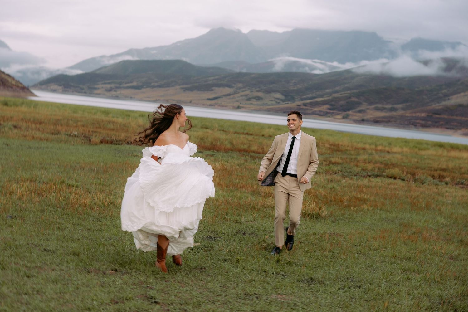 Wyoming elopement in the mountains. bridal couple running