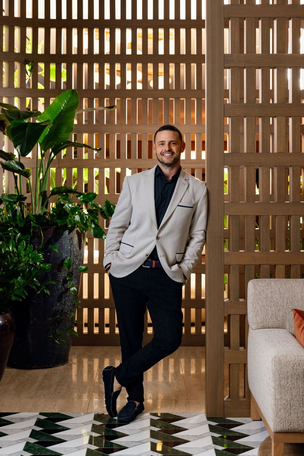 Professional portrait of a South Florida developer framed by custom architectural details in a luxury residential setting.