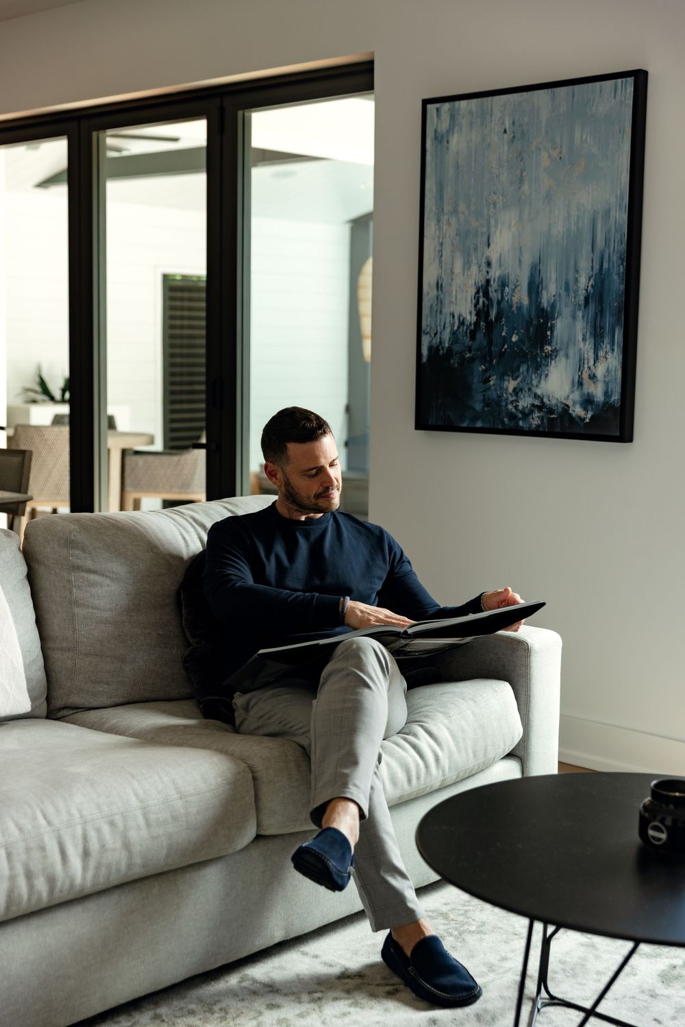 Lifestyle branding image of a real estate developer reviewing project materials inside a contemporary luxury home.