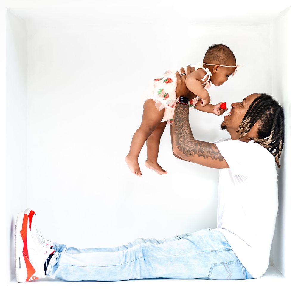 A tender moment against a white background showing parental affection and bonding.