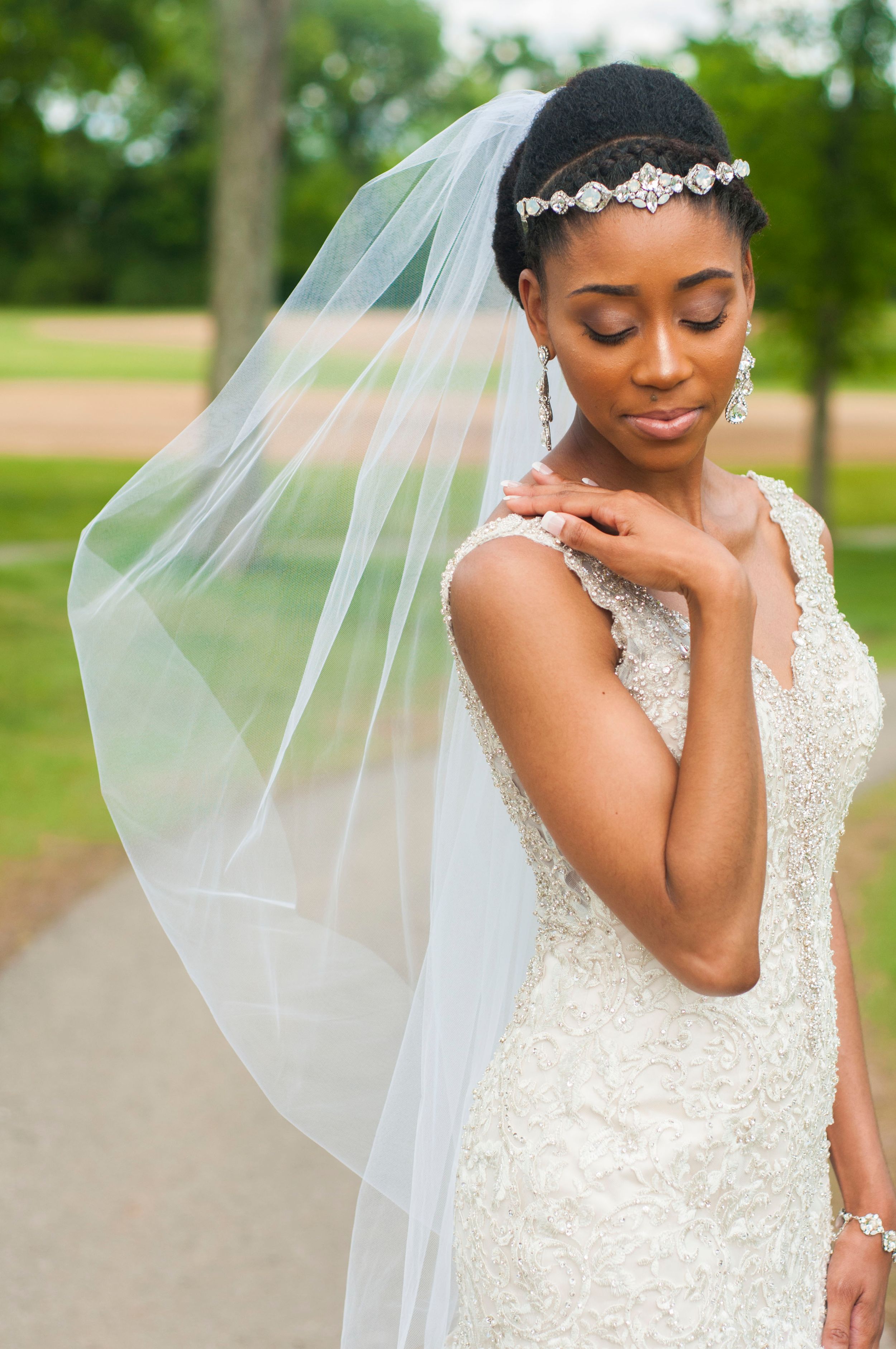 bride looking down at shoulder with long veil on wedding day