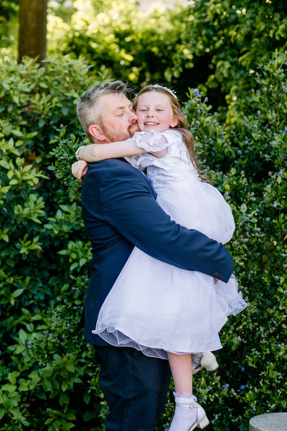 Natural First Communion photography at Shamrock Lodge Hotel Athlone, emotional father and daughter connection.